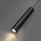 Clérachic black cylindrical pendant lamp on its cord, photographed close against grey with a warm glow at its tip.