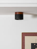 Unlit, this Clérachic flush ceiling light sits at a white ceiling edge, a pink-framed print on the wall beneath.