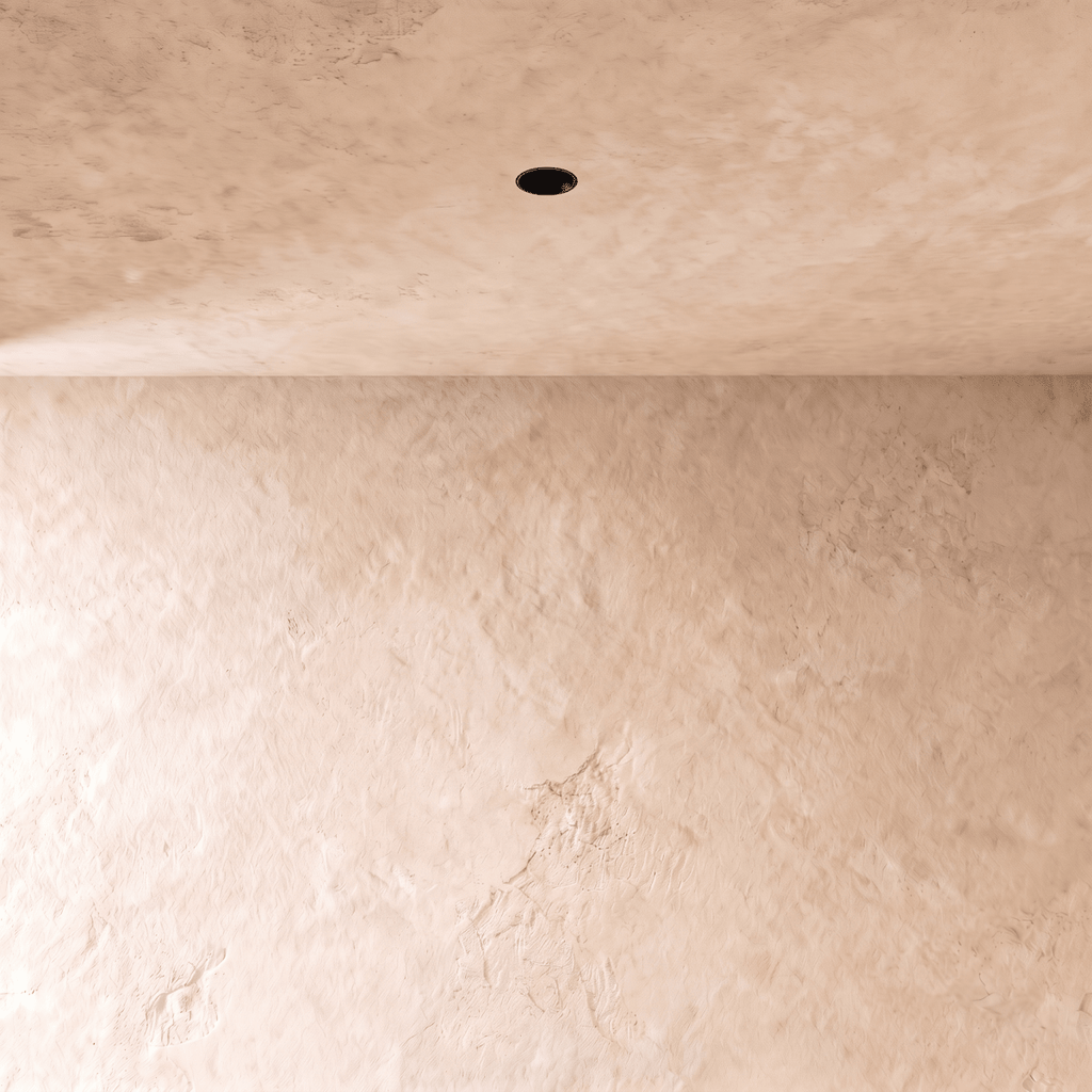 Clérachic black trimless downlight recessed flush into a plaster ceiling, with only a small dark aperture showing.