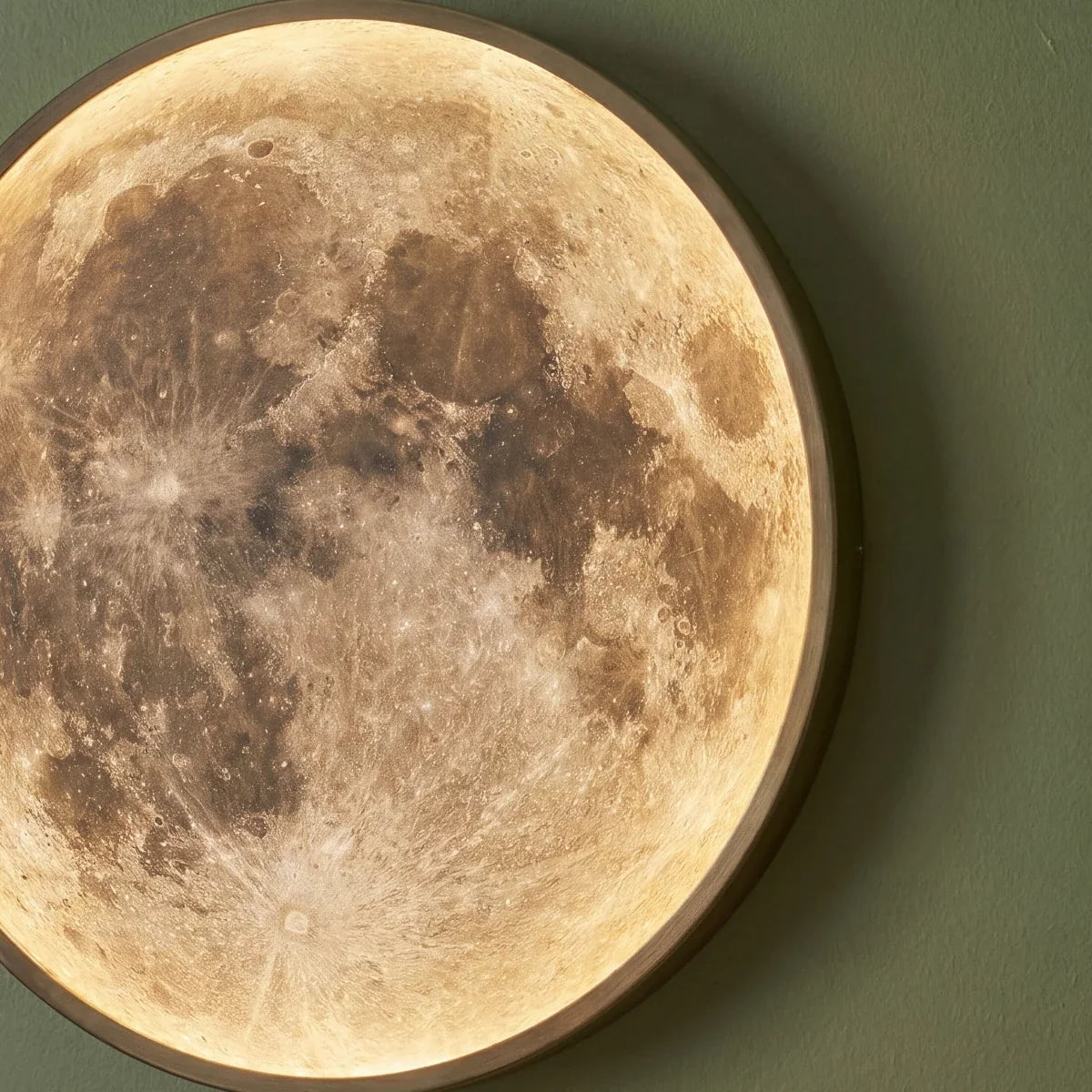 Clérachic illuminated moon wall lamp in close detail, showing the textured lunar surface and dark rim.