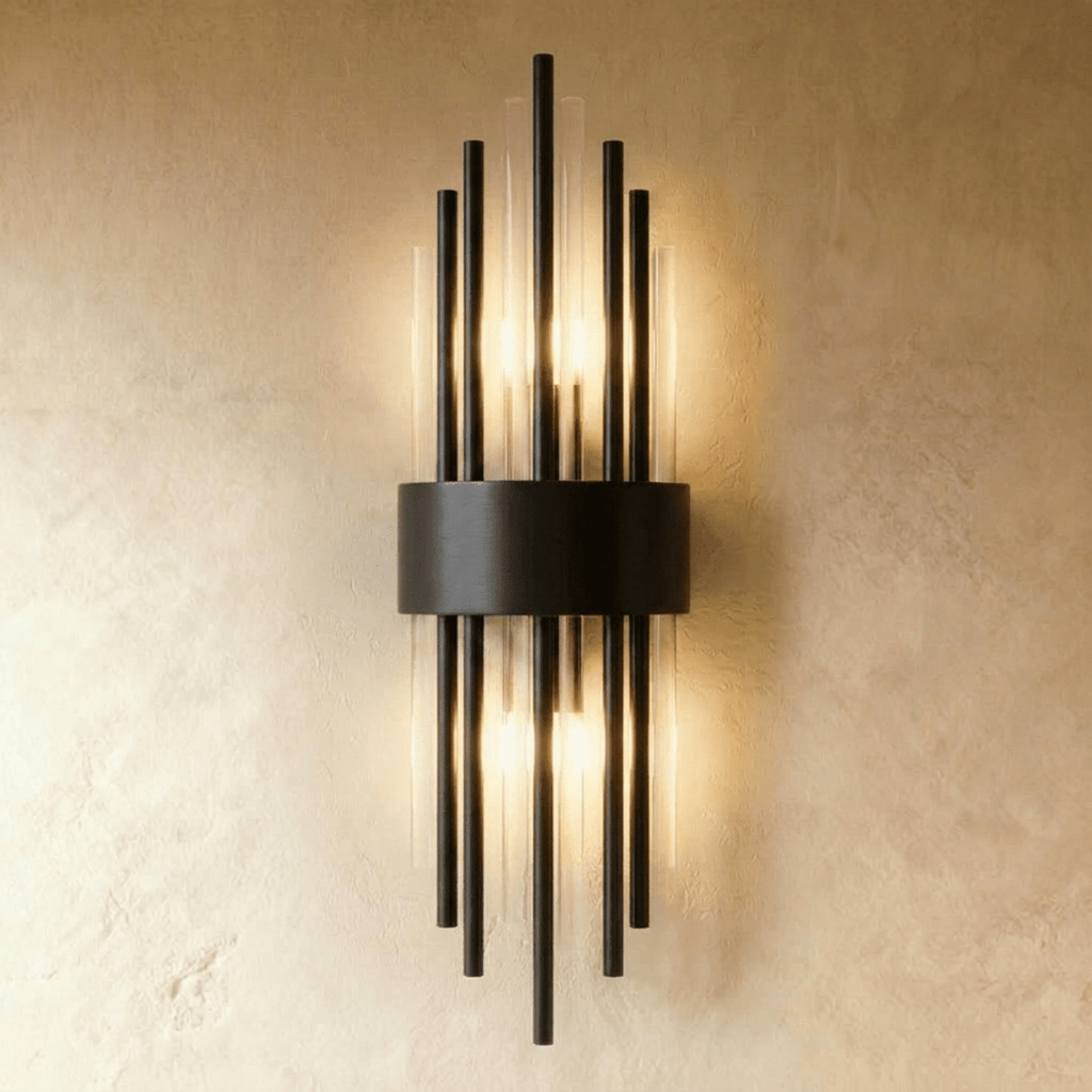 Clérachic black metal wall sconce with tall fluted glass rods fanning from a curved backplate on a plaster wall.