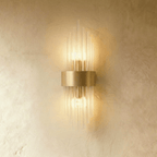 Clérachic brass wall sconce with a compact spray of fluted glass rods around a curved gold-tone backplate.