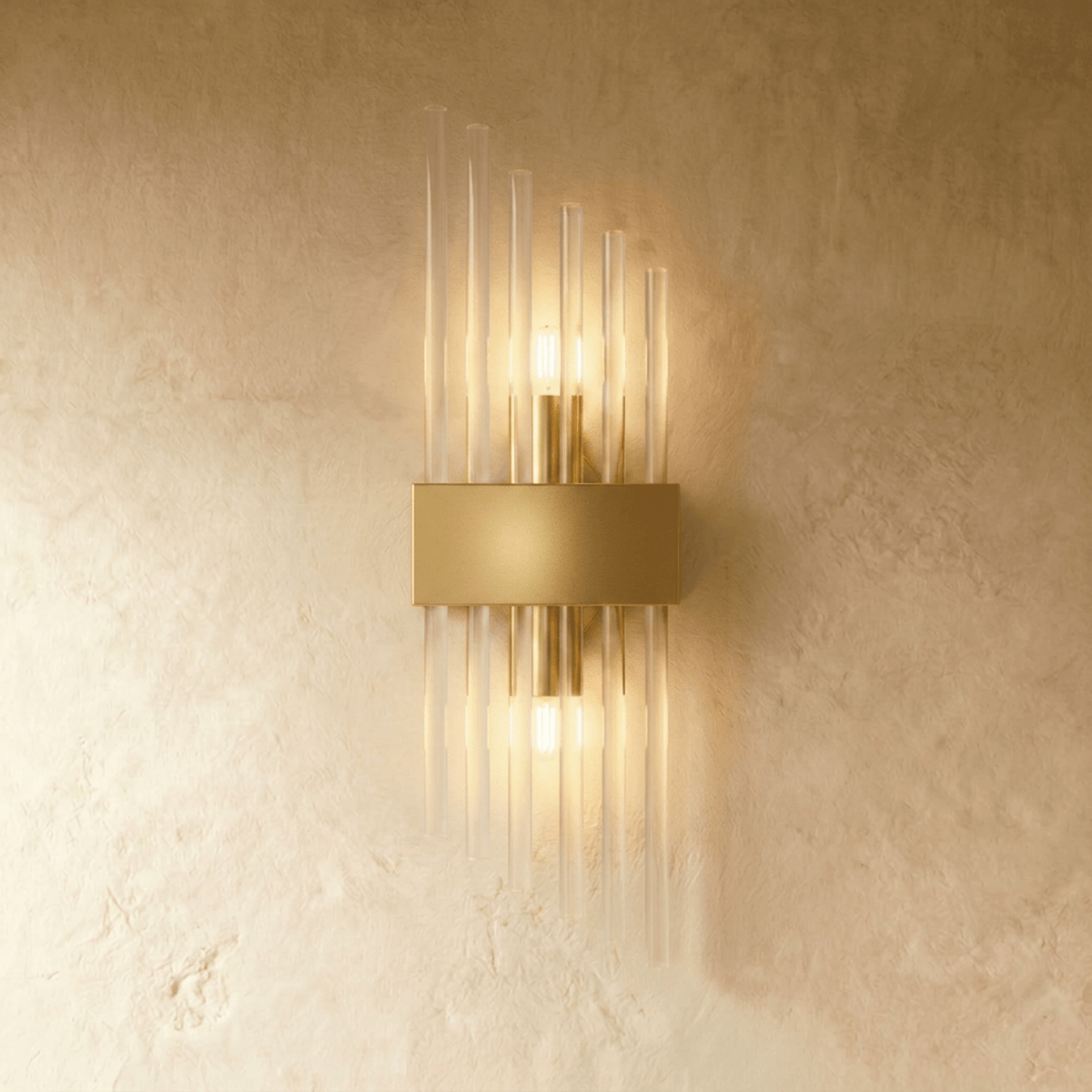 Clérachic brass wall sconce with a shorter spray of fluted glass rods on a rectangular gold-tone backplate.