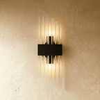 Clérachic black metal wall sconce with a shorter spray of fluted glass rods on a rectangular backplate.
