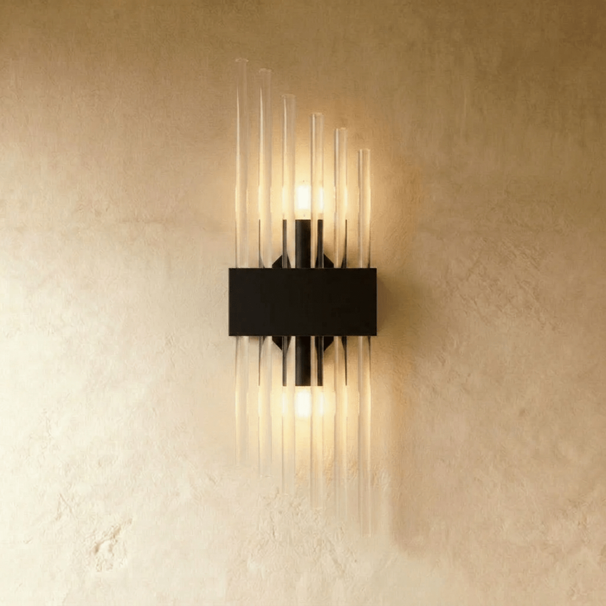 Clérachic black metal wall sconce with a shorter spray of fluted glass rods on a rectangular backplate.