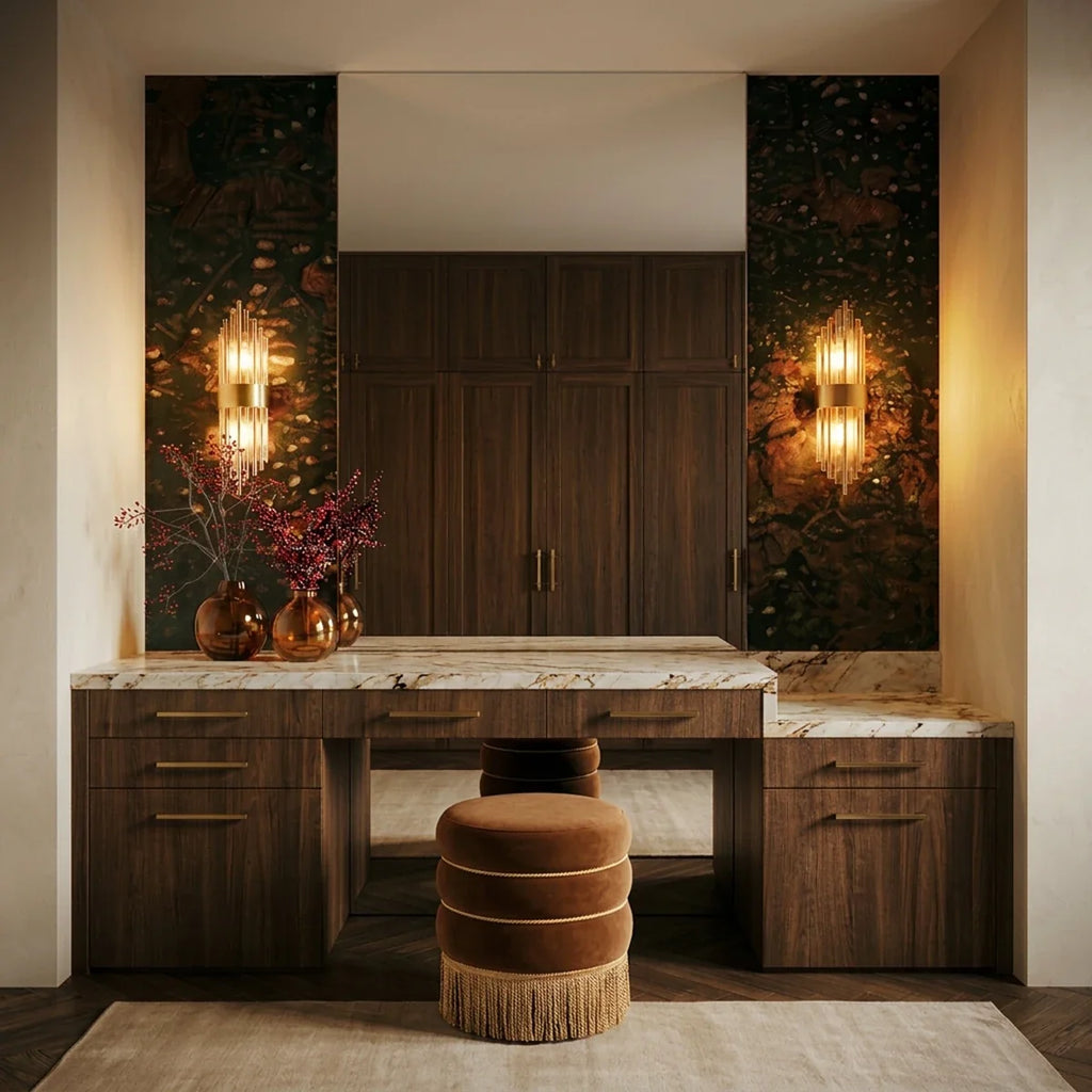 Clérachic brass wall sconces flanking a mirror above a marble vanity counter with amber glass vases.