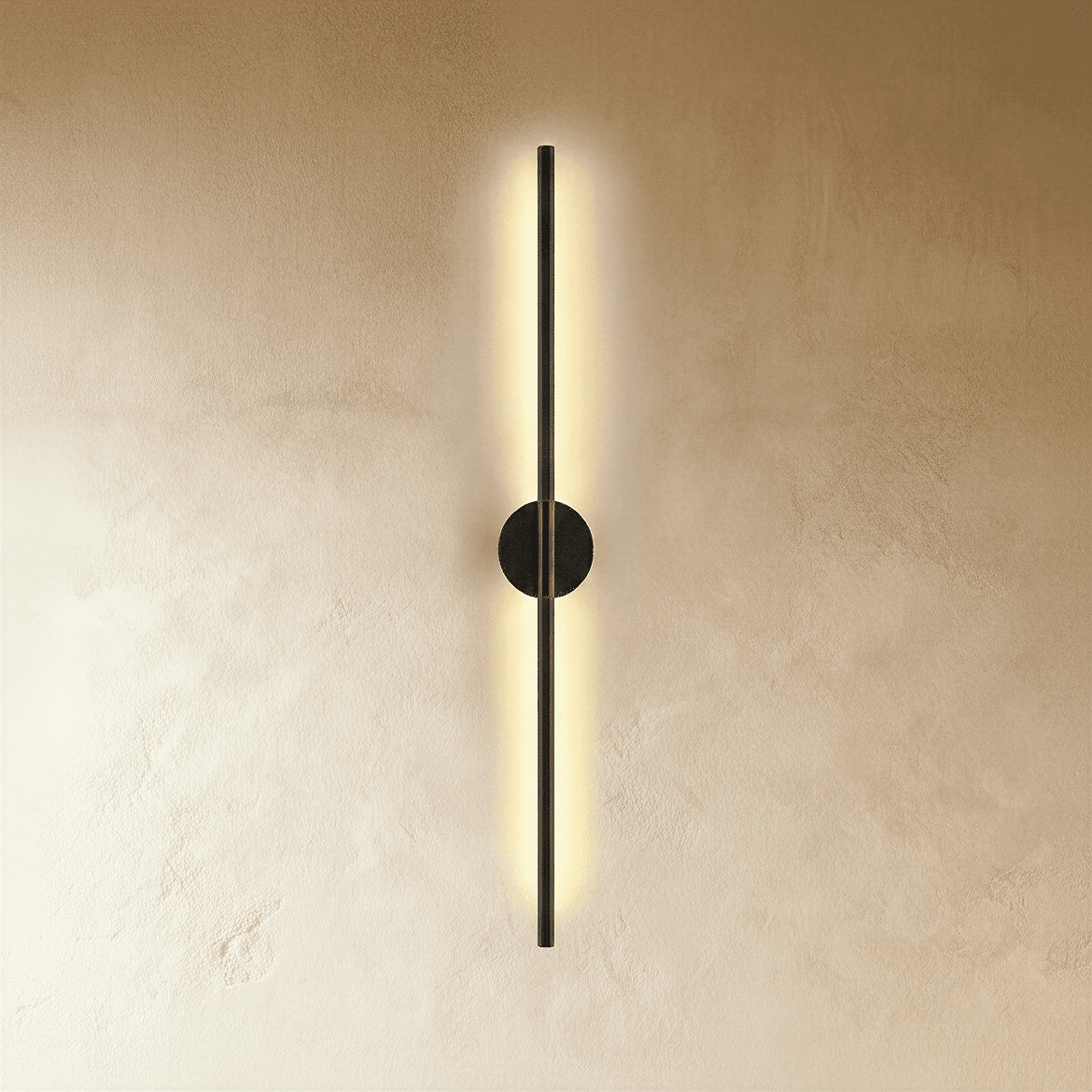 Clérachic black slim wall light glows along its full length, round canopy centred on a warm plaster wall.