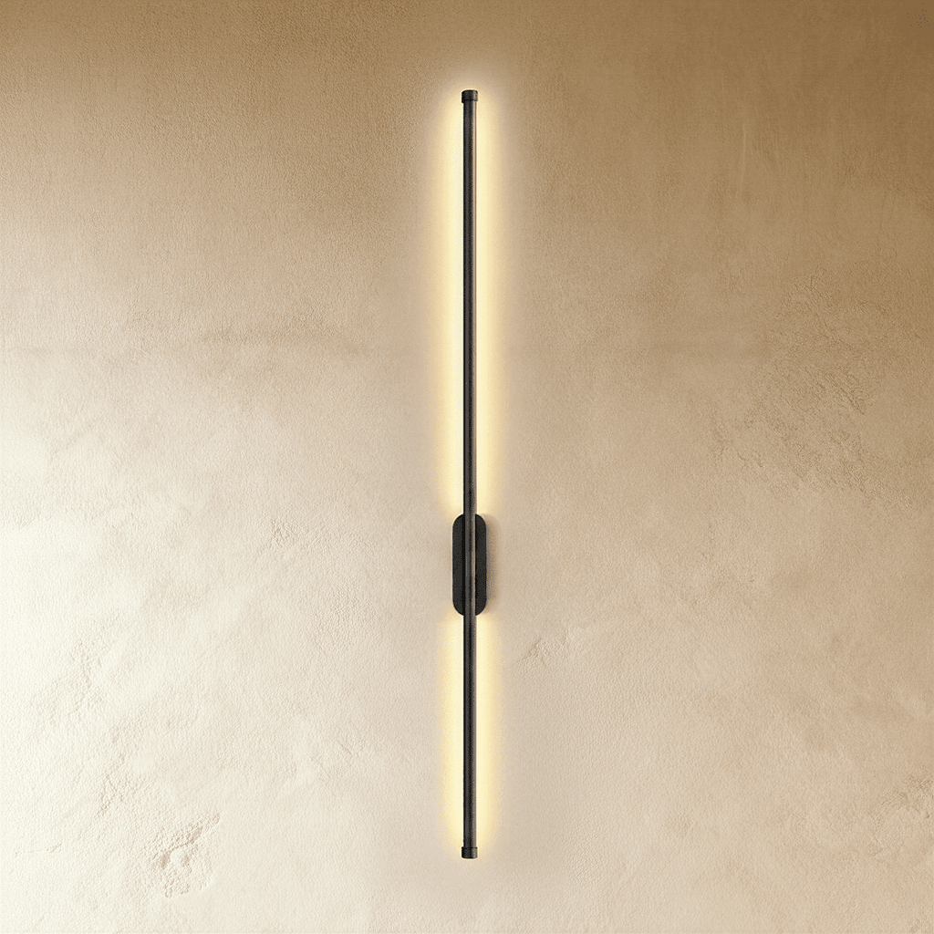 Clérachic black slim wall light glows top to bottom, its oval canopy set midway on a plaster wall.