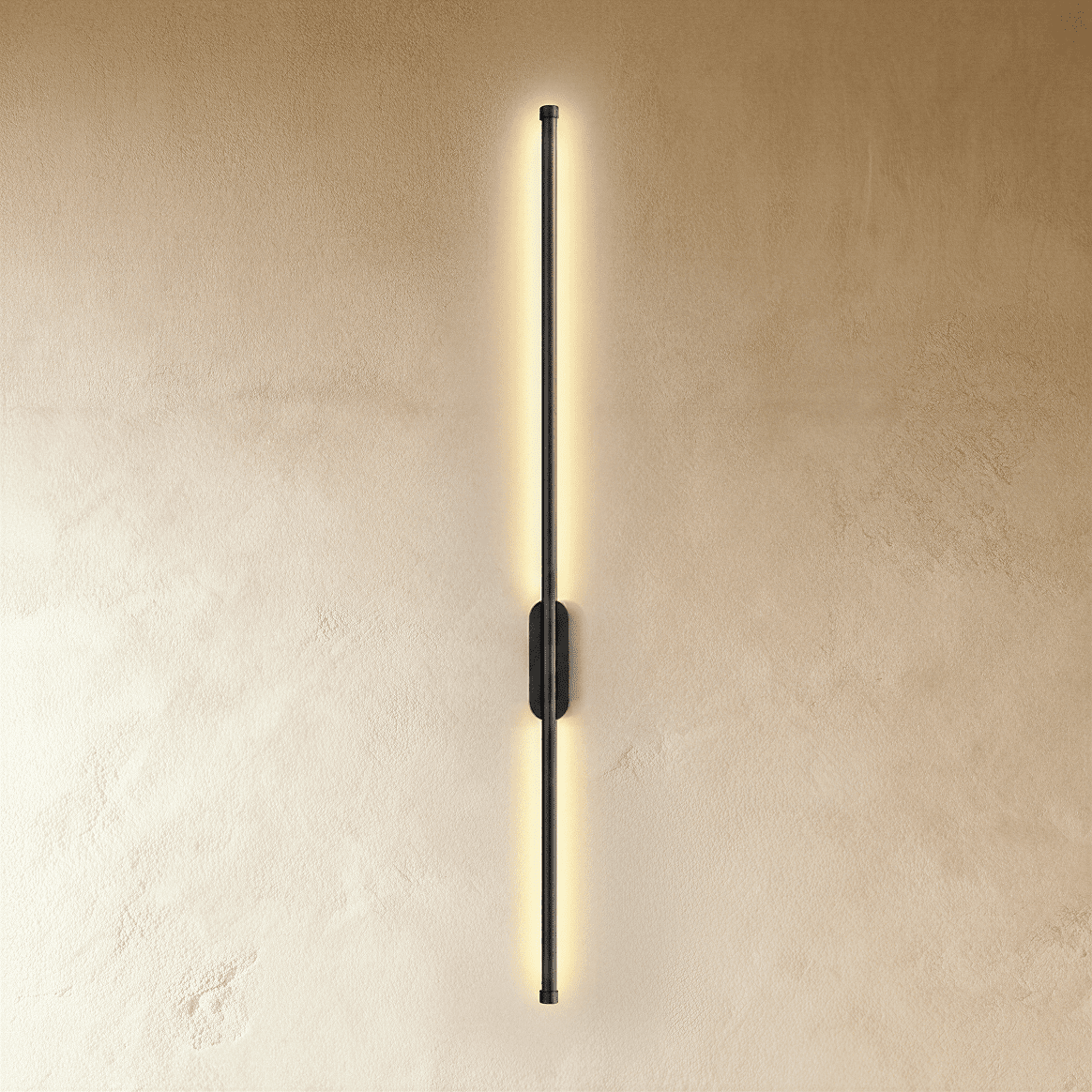 Clérachic black slim wall light glows top to bottom, its oval canopy set midway on a plaster wall.