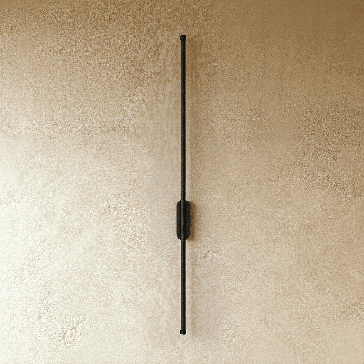 Clérachic black slim wall light shown unlit, a thin rod fixed by an oval canopy to a plaster wall.