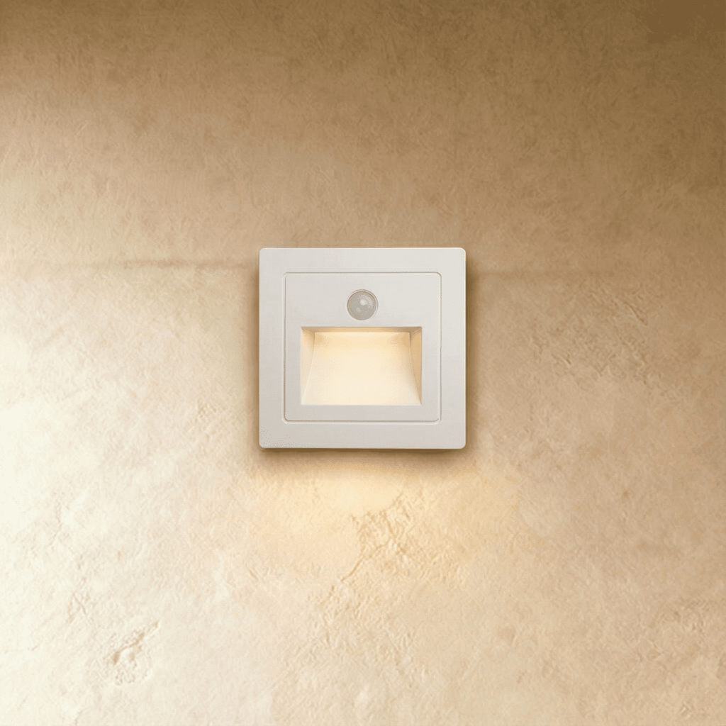 The same recessed step light in white shows its motion sensor eye and angled light chamber in this Clérachic hero shot.