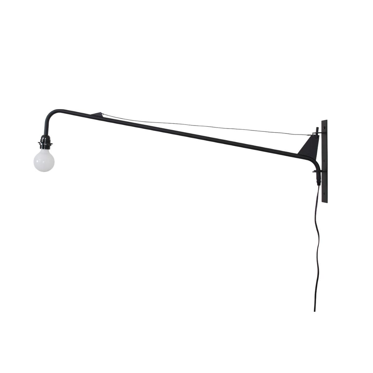 Black swing-arm wall light from Clérachic on a plain white background, with a white globe bulb, wall plate and cord.
