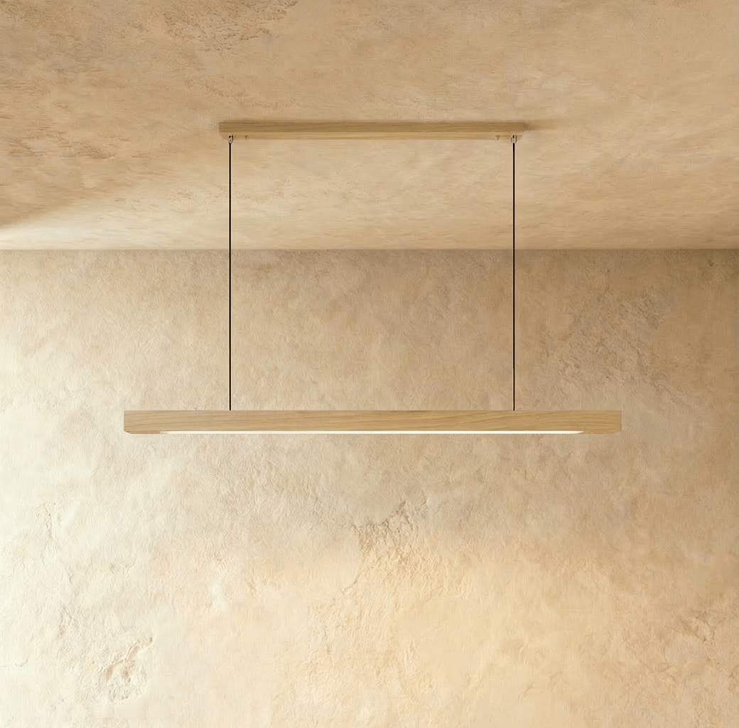 This Clérachic pine pendant bar hangs from a single slim horizontal ceiling canopy, glowing softly below.