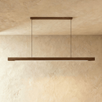 The Clérachic black walnut pendant bar hangs level between two round black ceiling canopies here.