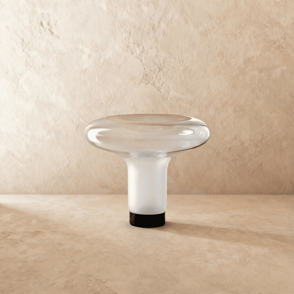 Clérachic mushroom-shaped blown-glass table lamp with a wide clear dish top and frosted white stem, unlit on a limewash backdrop.