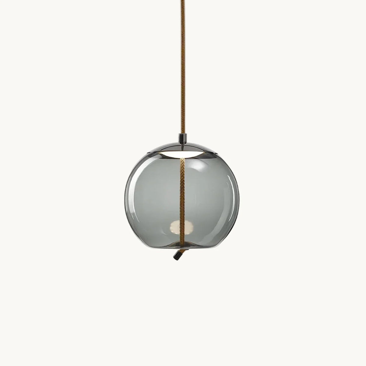 A round smoke-grey glass Clérachic pendant hangs from a braided rope cord on a plain white backdrop, with a small light visible inside.