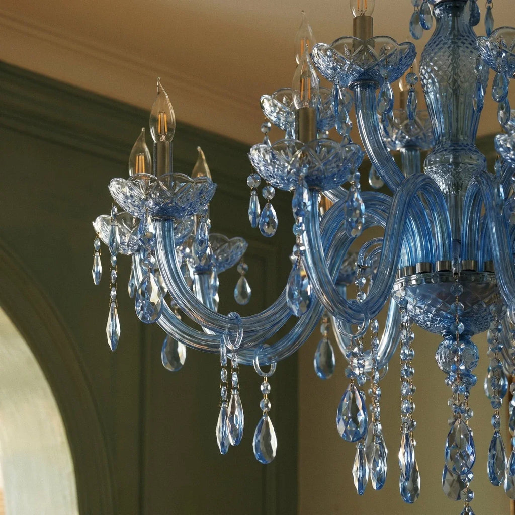 Close view of Clérachic blue chandelier arms, faceted cut-glass bobeches and crystal drops, with candle-style bulbs