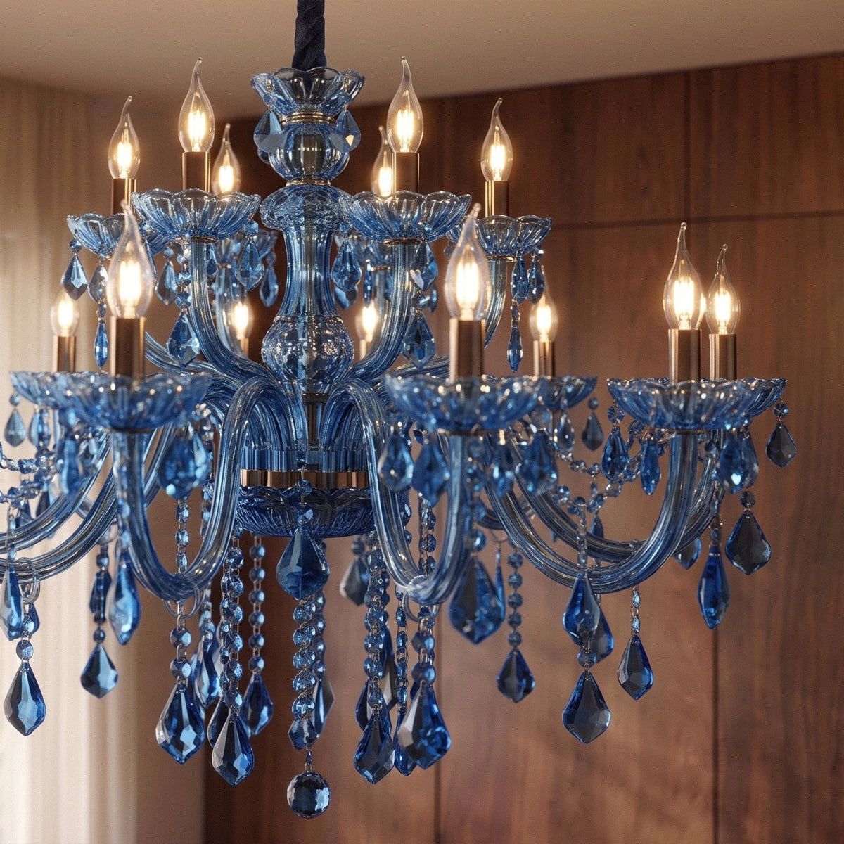 Close view of the Clérachic blue chandelier in two tiers, lit candle-style bulbs, glass arms and beaded crystal strands