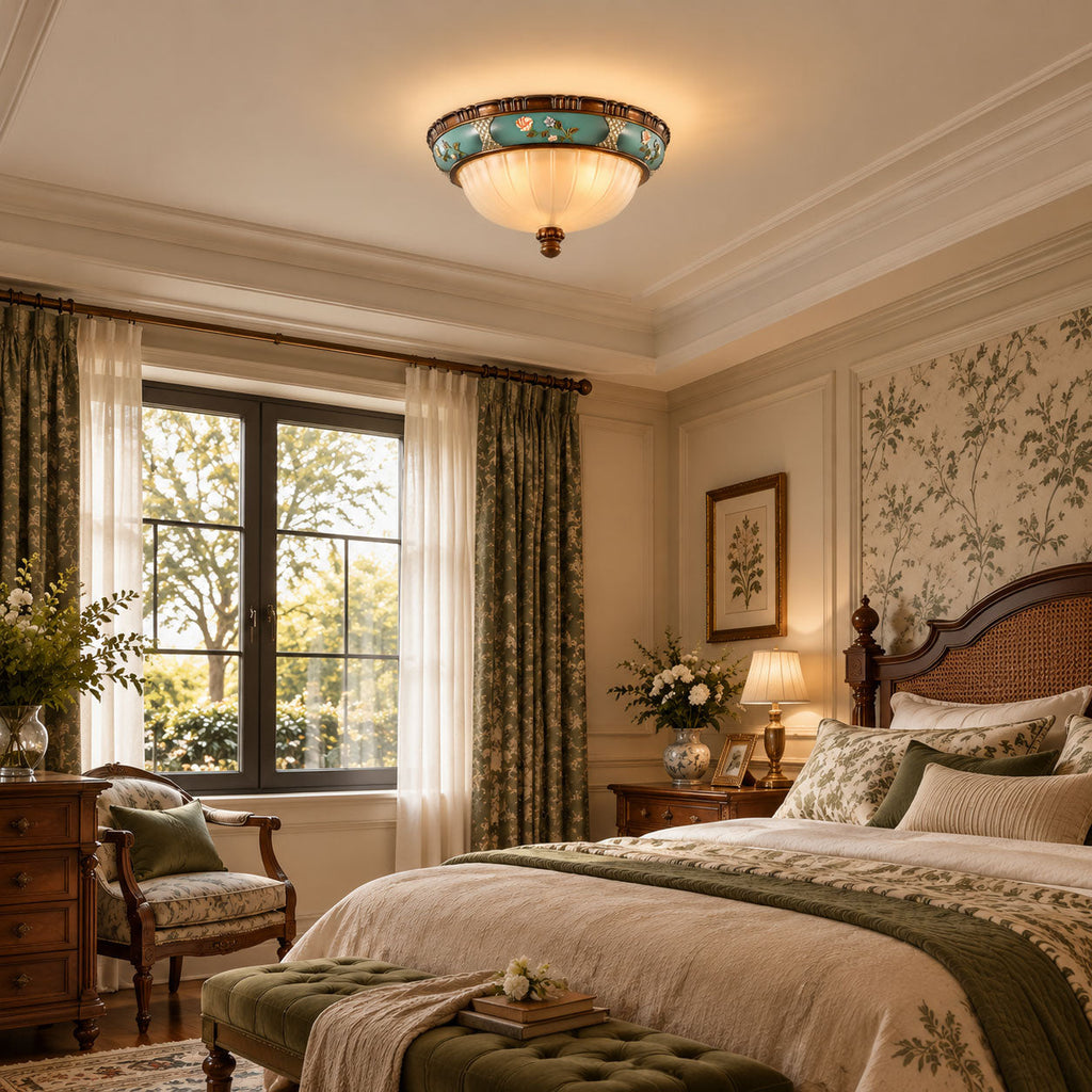 Lit Clérachic ceiling light in a cream bedroom with a wood bed, green curtains and floral wallpaper.