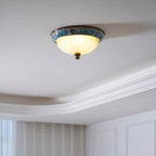 Clérachic ceiling light on a white tray ceiling with moulding, lit softly, with sheer curtains and a panelled wall below.
