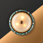 Looking up at this Clérachic ceiling light from below, three lamps glowing behind the frosted glass inside a turquoise flower-decorated rim.