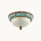 Unlit Clérachic ceiling light on a white backdrop, the milky glass bowl showing a pale blue tint under a turquoise floral band.
