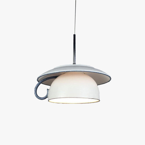 Clérachic pendant light lit, the glow through the shade in a quiet room.