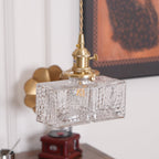 Clérachic boxy hammered-glass pendant light, compact Model A size, hanging beside a brass fan sconce and framed wall art.