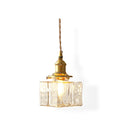 Studio shot of the lit Clérachic boxy hammered-glass pendant light in Model A size, showing the full cord drop on white.