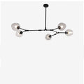Studio view of the Clérachic chandelier: five gradient gray globes on cranked black arms branching from one rigid stem.