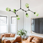Six-head Clérachic chandelier in gradient green glass, its black arms reaching further across the same bay-window living room.
