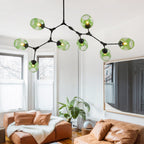 The eight-head Clérachic chandelier spreads gradient green globes wide across a white ceiling, each head cranked to its own angle.