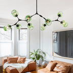 At nine heads the Clérachic chandelier reaches its full span, gradient green globes staggered in three dimensions over the room.