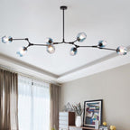 Clérachic chandelier in gradient blue glass on a black frame, lit along a ceiling above a sideboard and curtained window.