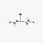 The Clérachic chandelier in black with clear dimpled globes, shown flat against white so the full branching frame reads.