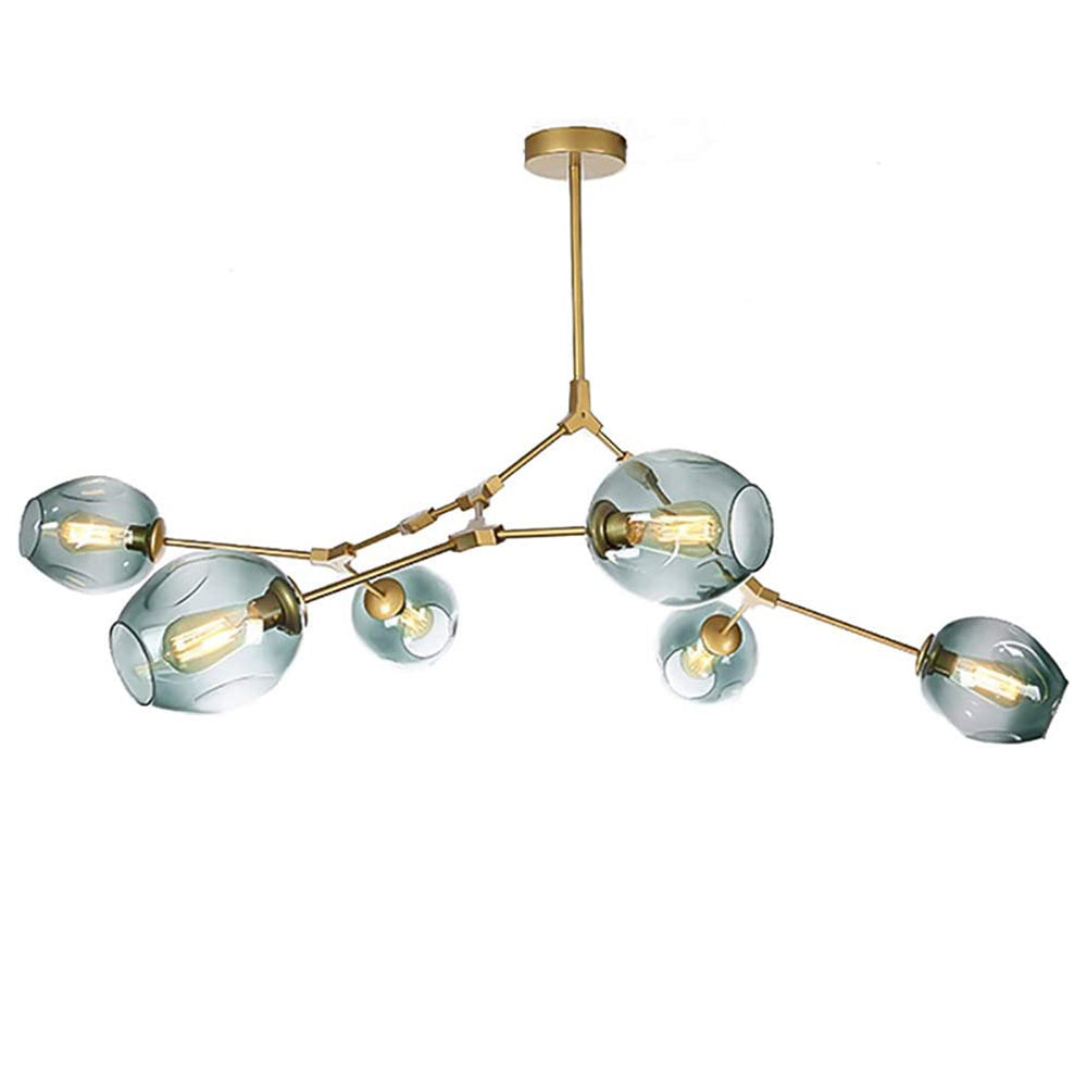Gold-armed Clérachic chandelier with gradient gray-green globes lit by filament bulbs, shown against a plain studio white.