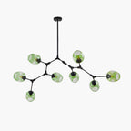 The eight-head Clérachic chandelier in black, gradient green globes staggered across the frame in a plain studio view.