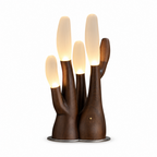 Cutout view of this Clérachic table lamp in dark wood, its branches glowing against a plain backdrop.