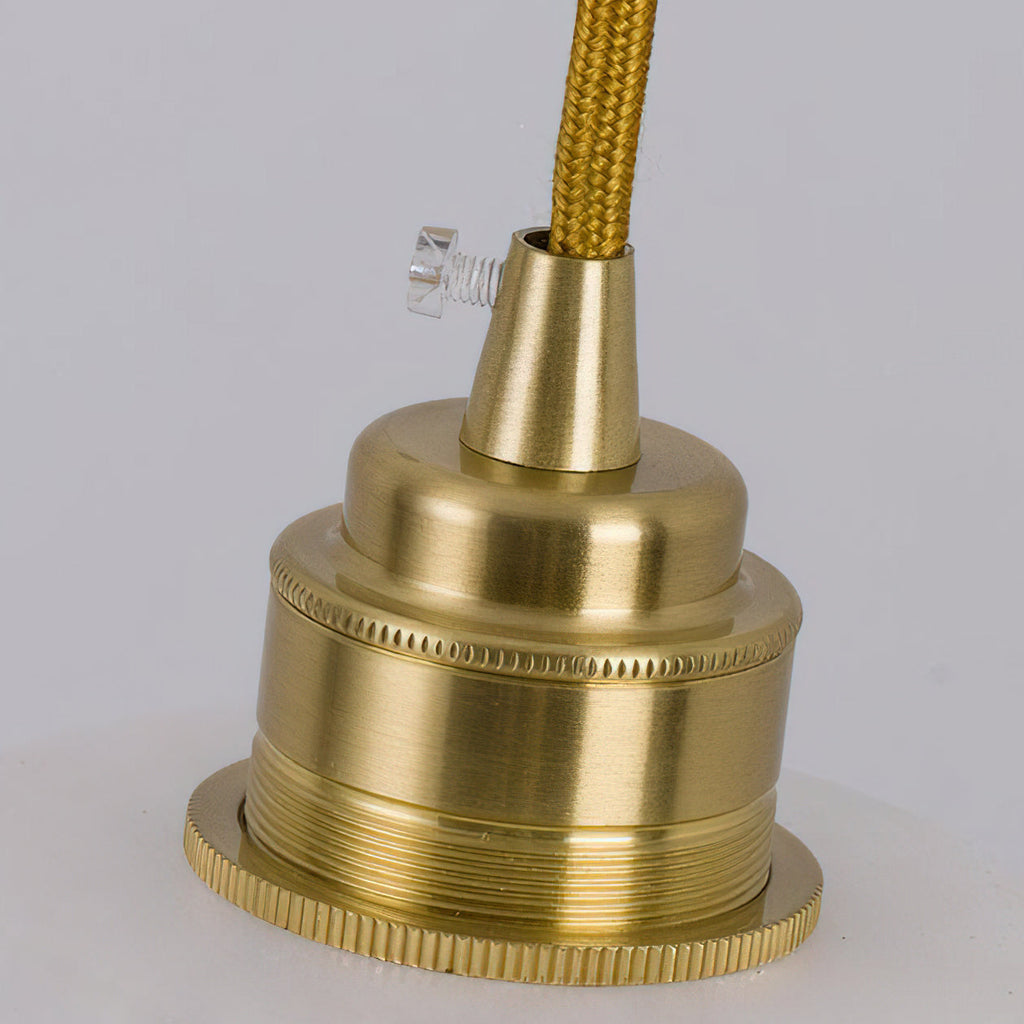 Close view of the brushed brass lamp holder and woven gold cord on this Clérachic pendant, with a small clear screw.
