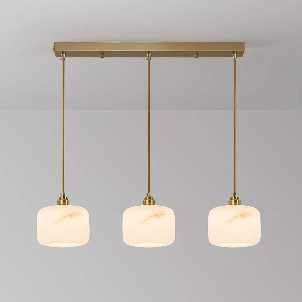 Three alabaster Clérachic pendants lit in a row from a long rectangular brass bar, with matching brass rods.