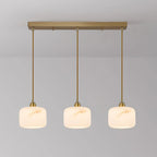 Three alabaster Clérachic pendants lit in a row from a long rectangular brass bar, with matching brass rods.