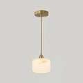 A single Clérachic alabaster pendant, brass rod and canopy, at the larger size on a plain light grey backdrop.
