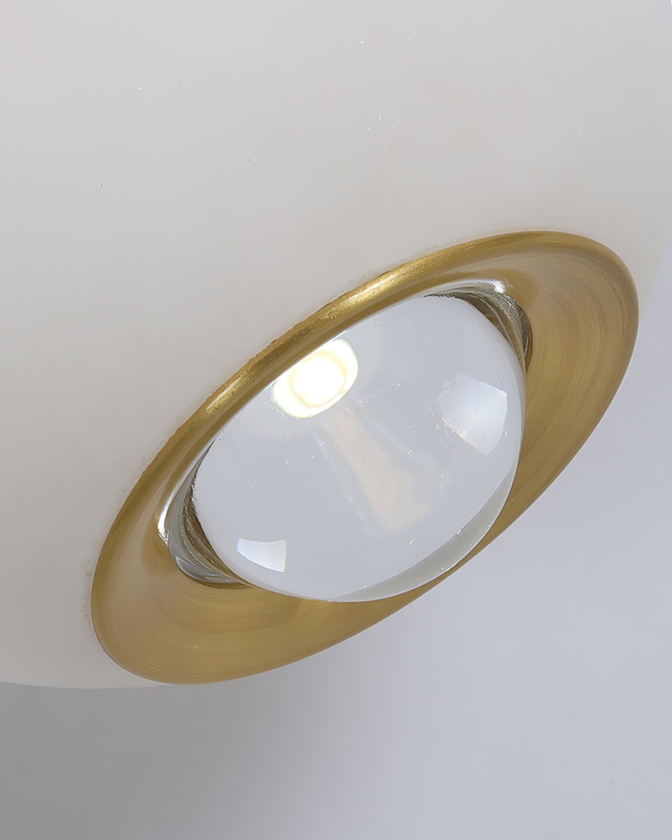 Underside of the Clérachic Brass and Alabaster Globe Cord Pendant Light, brass ring framing the clear lens over the LED.