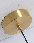 Brushed brass ceiling canopy of the Clérachic Brass and Alabaster Globe Cord Pendant Light with its black fabric cord.