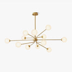 A brass Clérachic chandelier with long arms ending in frosted white globes, hanging from a short rod, on a plain white backdrop.