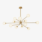 Brass Clérachic chandelier with a large cluster of cream-white globes on a plain off-white backdrop.