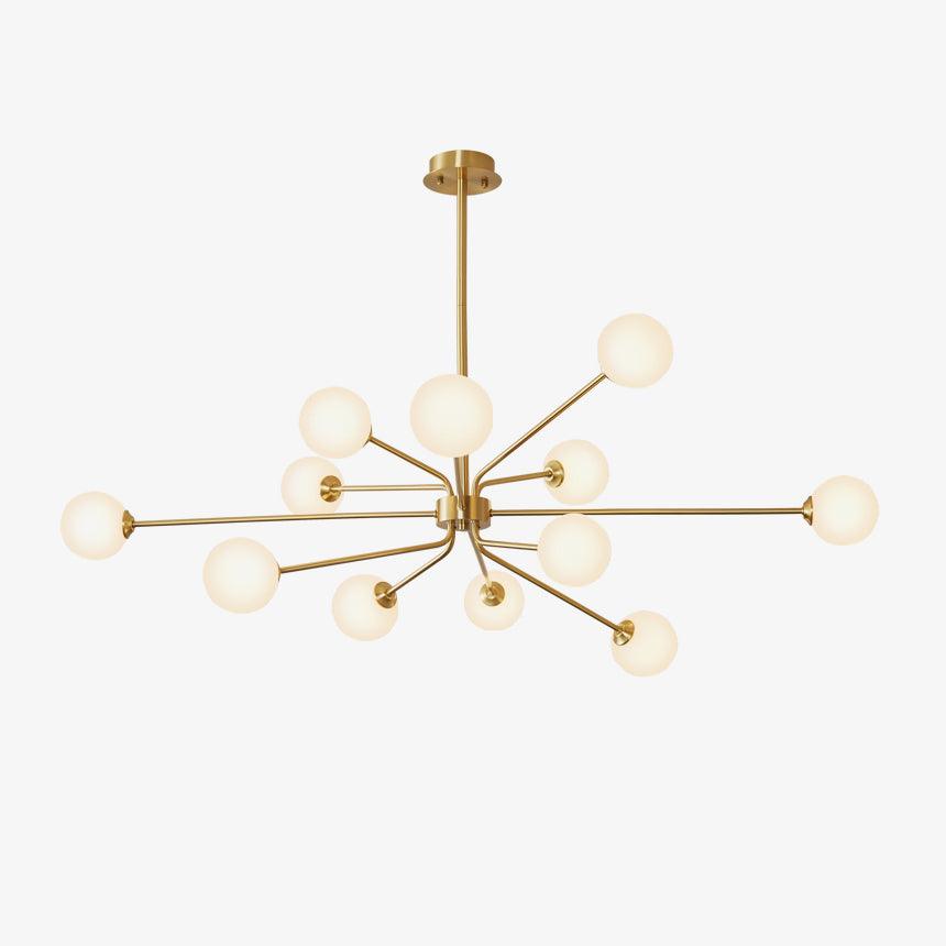 Brass Clérachic chandelier with a large cluster of cream-white globes on a plain off-white backdrop.