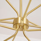 Close view of the brass hub, ceiling-facing arms and central stem of this Clérachic chandelier.