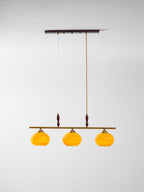 Clérachic three-head bar pendant on a pale backdrop, hung from a dark ceiling plate by one braided cord and one fine wire.