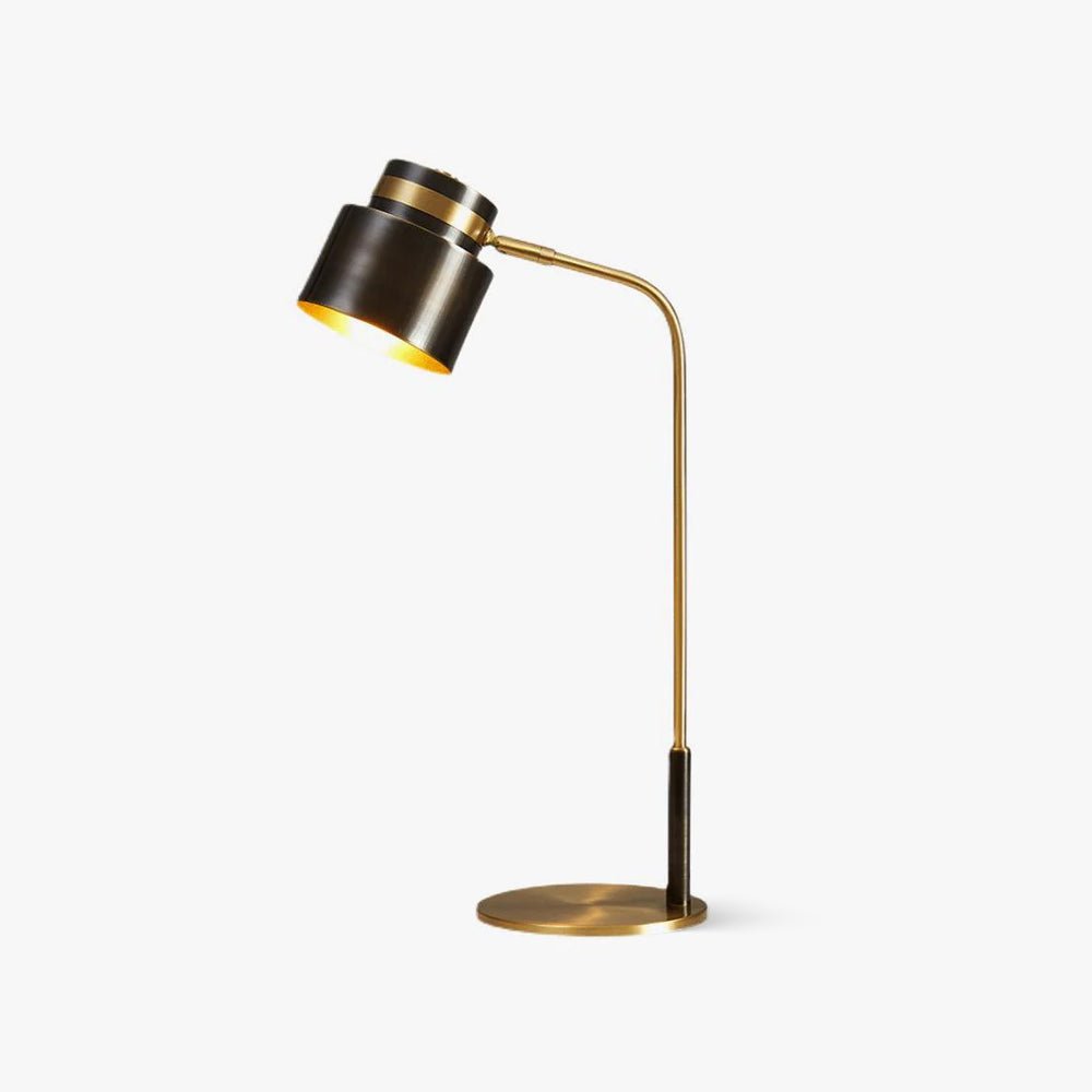 This Clérachic table lamp on a plain white backdrop, with a black drum shade, brass arm and round brass base.